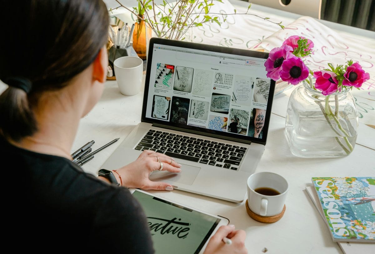 female reading laptop on desk