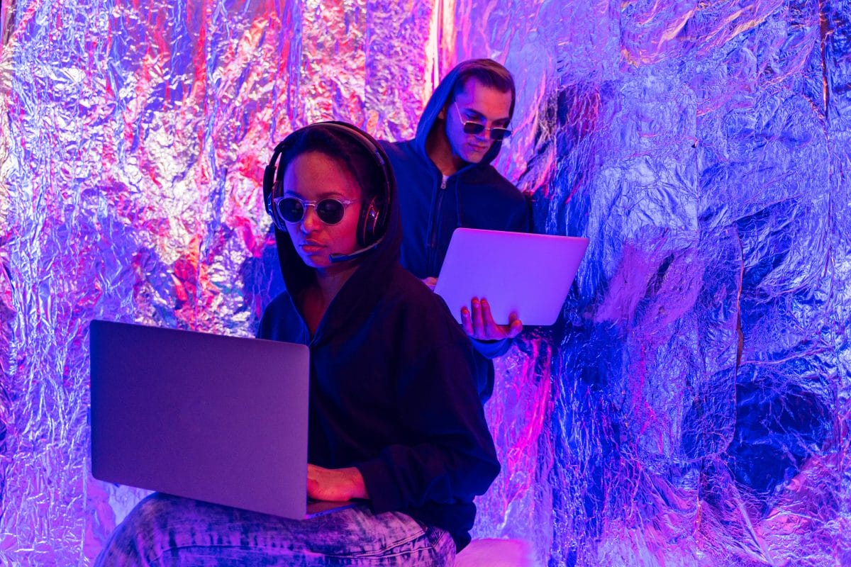 two people on laptops in a modern abstract setting