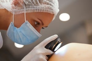 a dermatologist examines the skin.