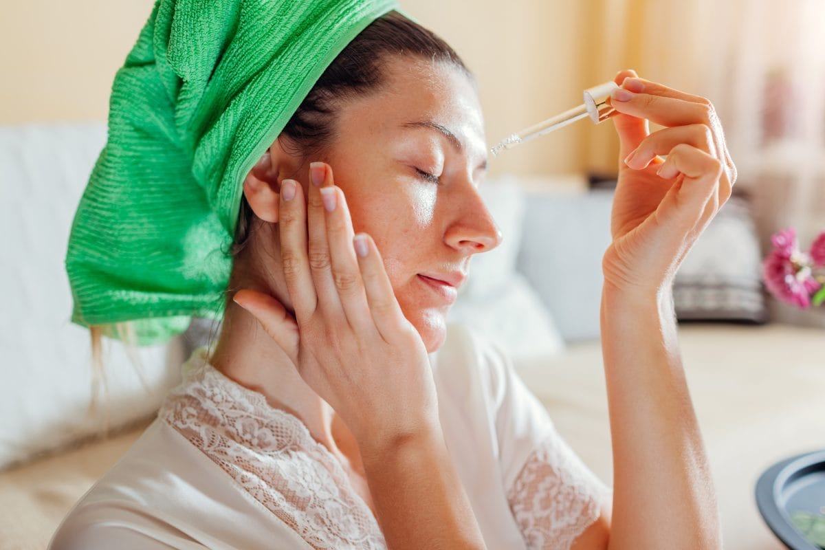 woman applying facial hyaluronic acid serum. skincare treatment. product for oily skin with acne and large pores