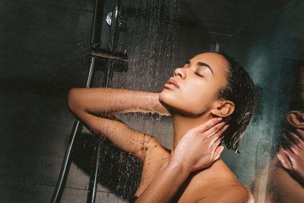 attractive tender african american girl taking shower