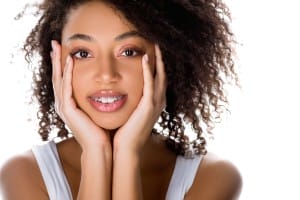 cheerful pretty african american girl with dental braces, isolated on white