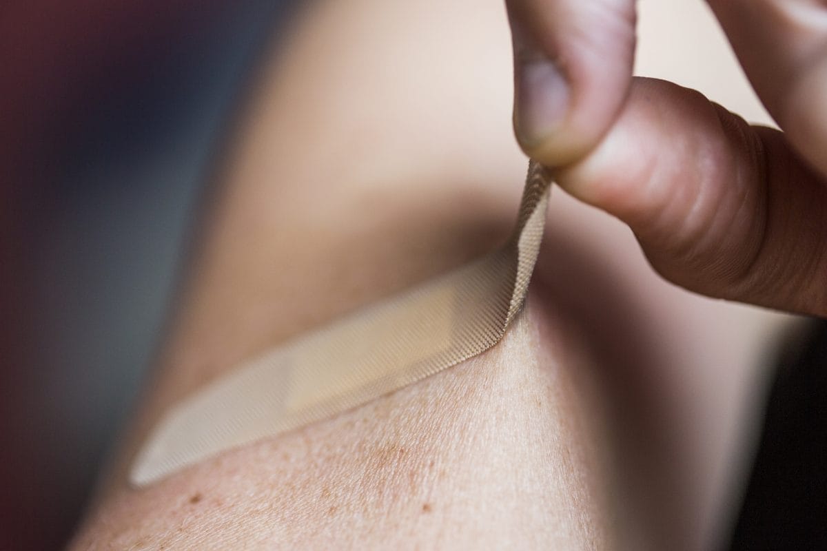 close up of man removing bandage