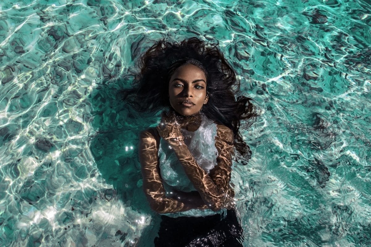 maldivian woman with blue eyes floating in water