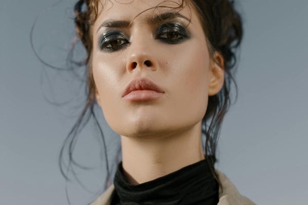 fierce looking female with dark eye makeup