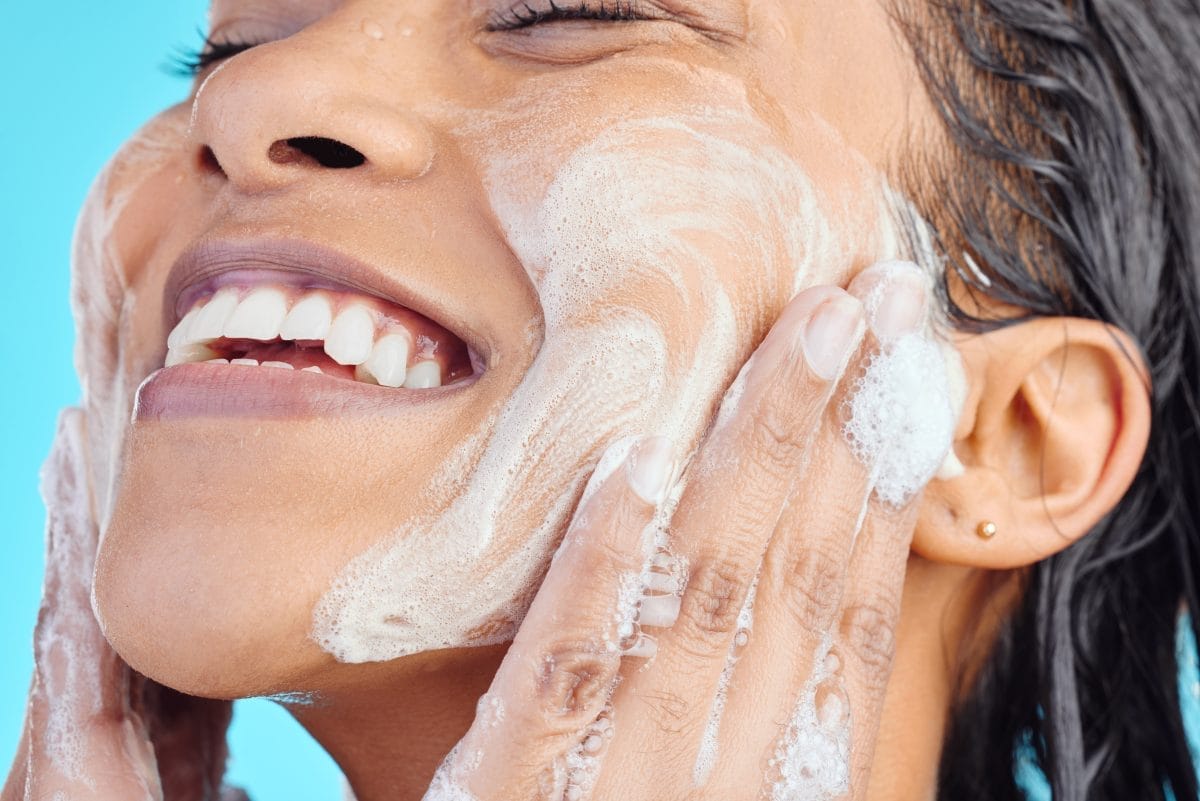 studio shot of a young woman washing her face whil 2023 11 27 04 49 59 utc (1)