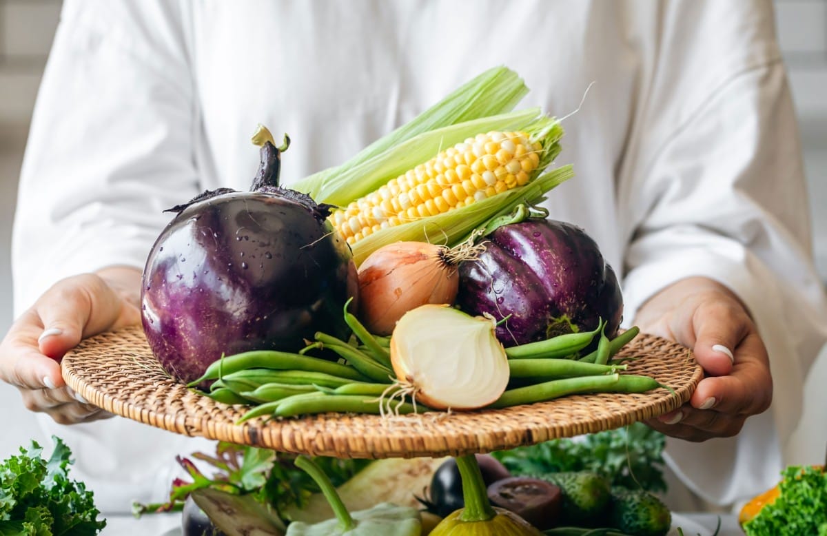 a woman holds a plate with eggplant onion corn a 2023 11 27 04 48 06 utc