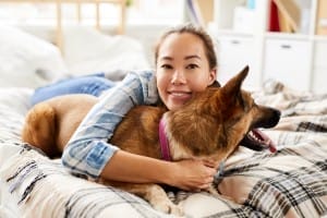 asian woman hugging dog