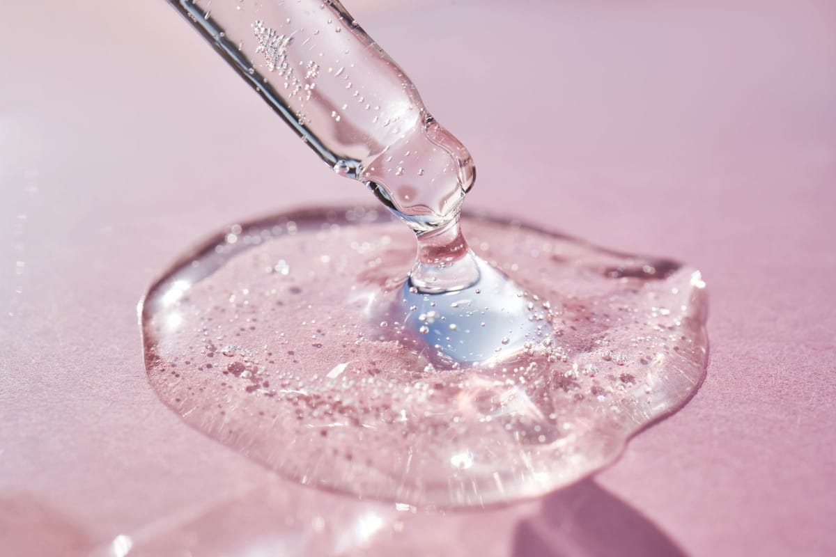 pipette with serum shimmering in the sun on a pink 2024 05 20 16 42 54 utc