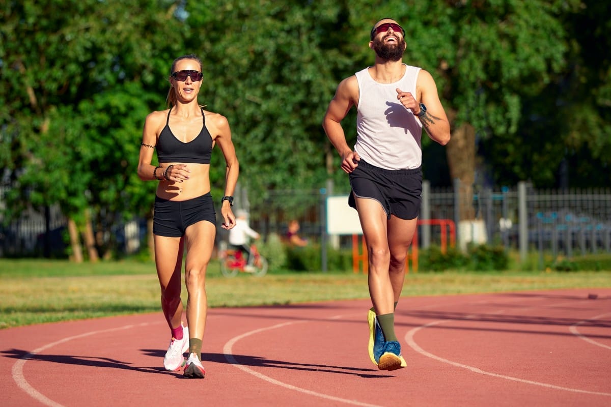 woman and man jogging in the stadium