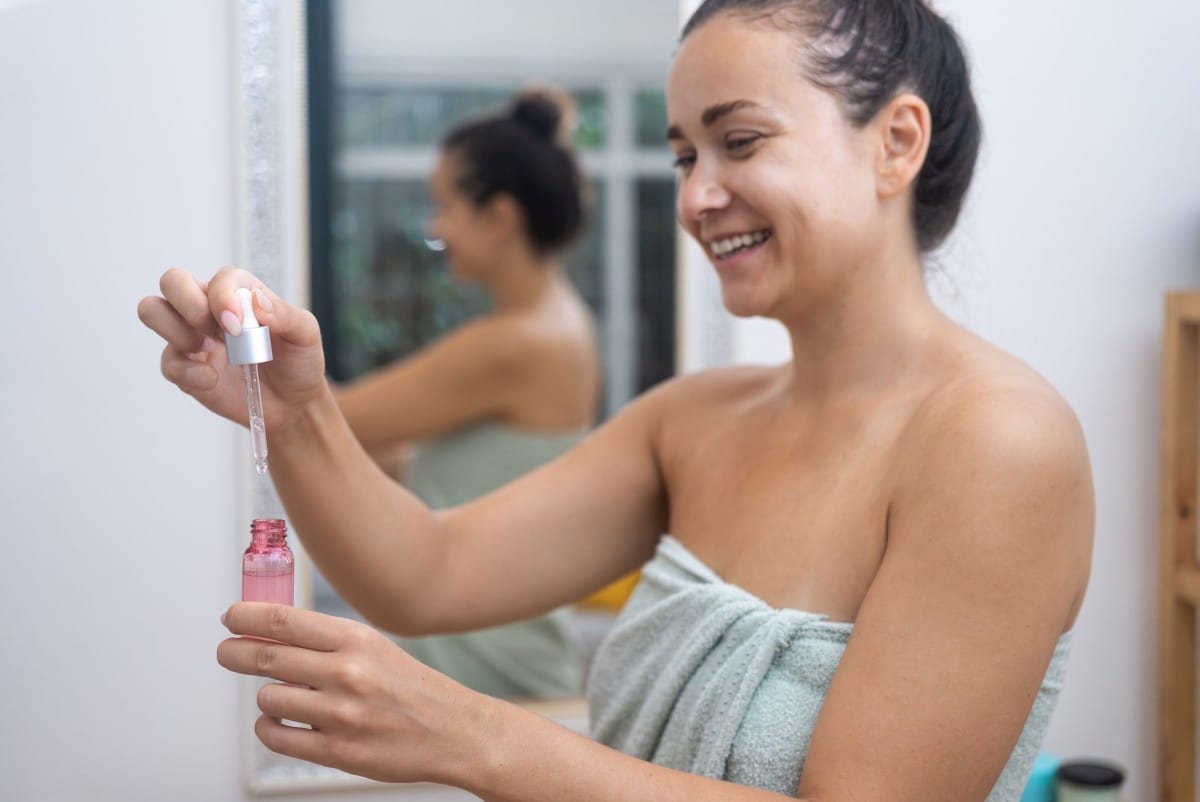 woman uses a serum dropper to apply hyaluronic aci 2023 11 27 05 04 46 utc