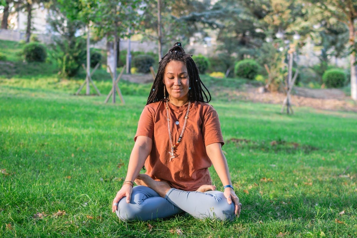 young woman is sitting in the lotus position and m 2023 11 27 05 26 09 utc