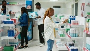 african american woman checking boxes of medicine