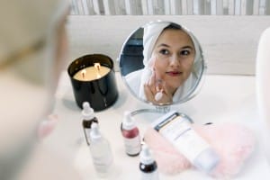 woman using a rose quartz roller on her skin in a 2023 11 27 05 03 21 utc