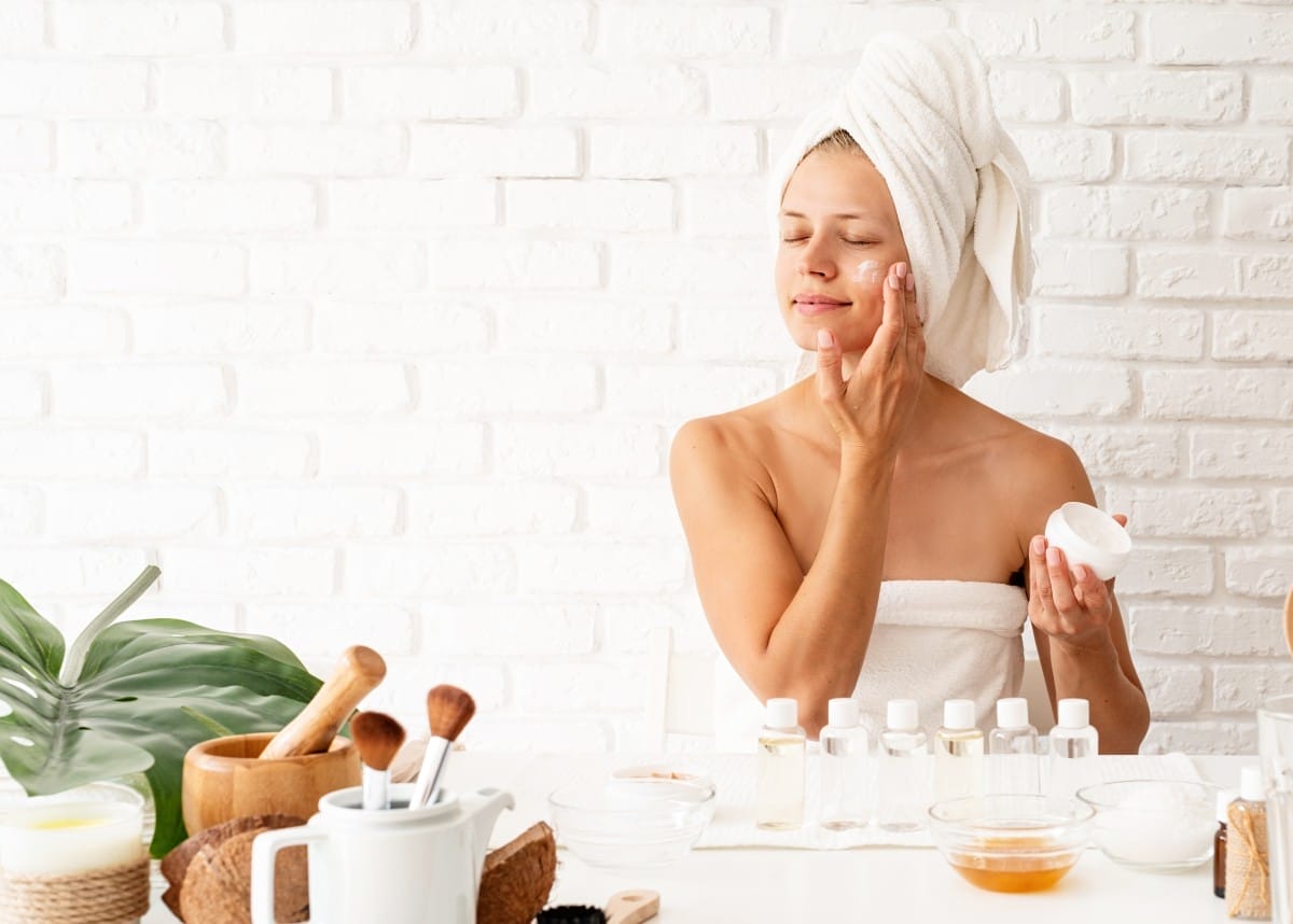 happy young woman in white bathtowels applying cre 2023 11 27 05 22 39 utc