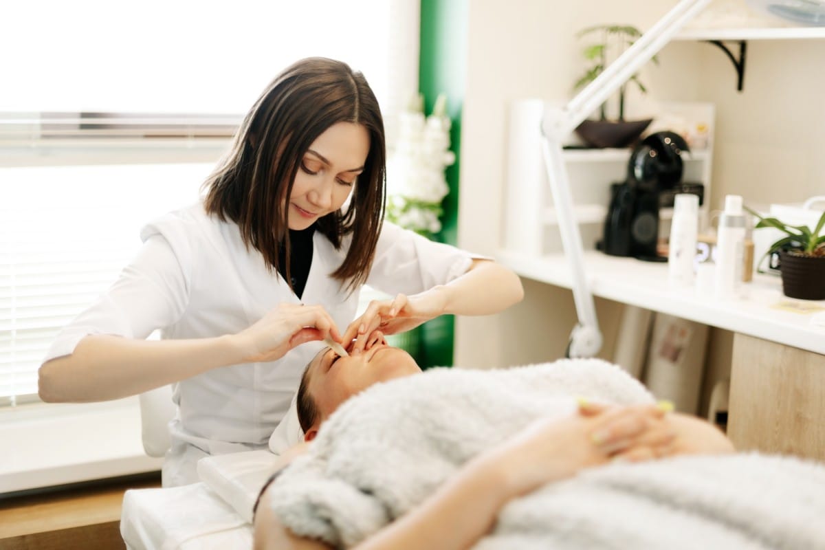 a cosmetologist massages the skin of a young woman 2023 11 27 05 21 05 utc