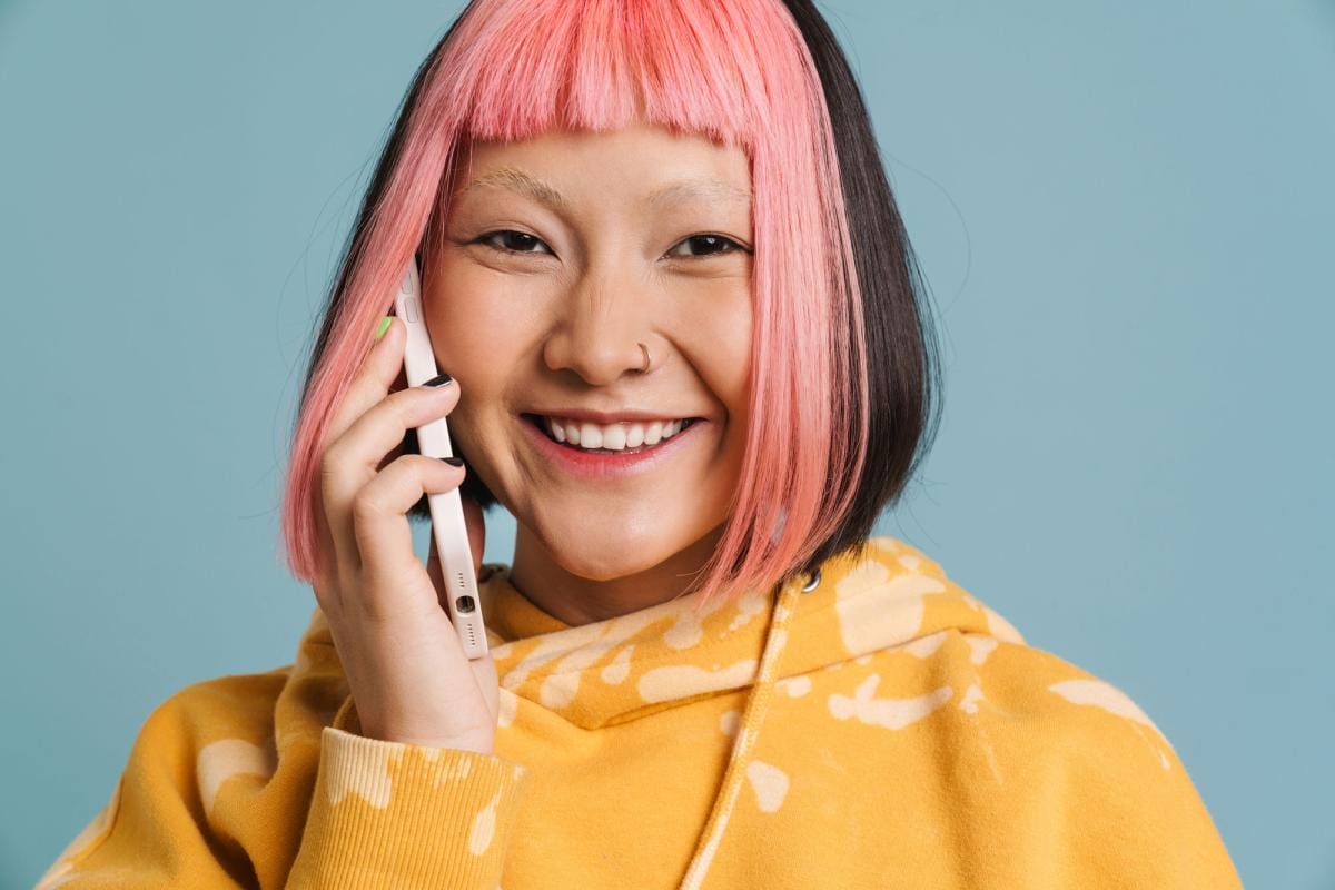 asian girl with pink hair smiling and talking on m 2023 11 27 05 21 20 utc