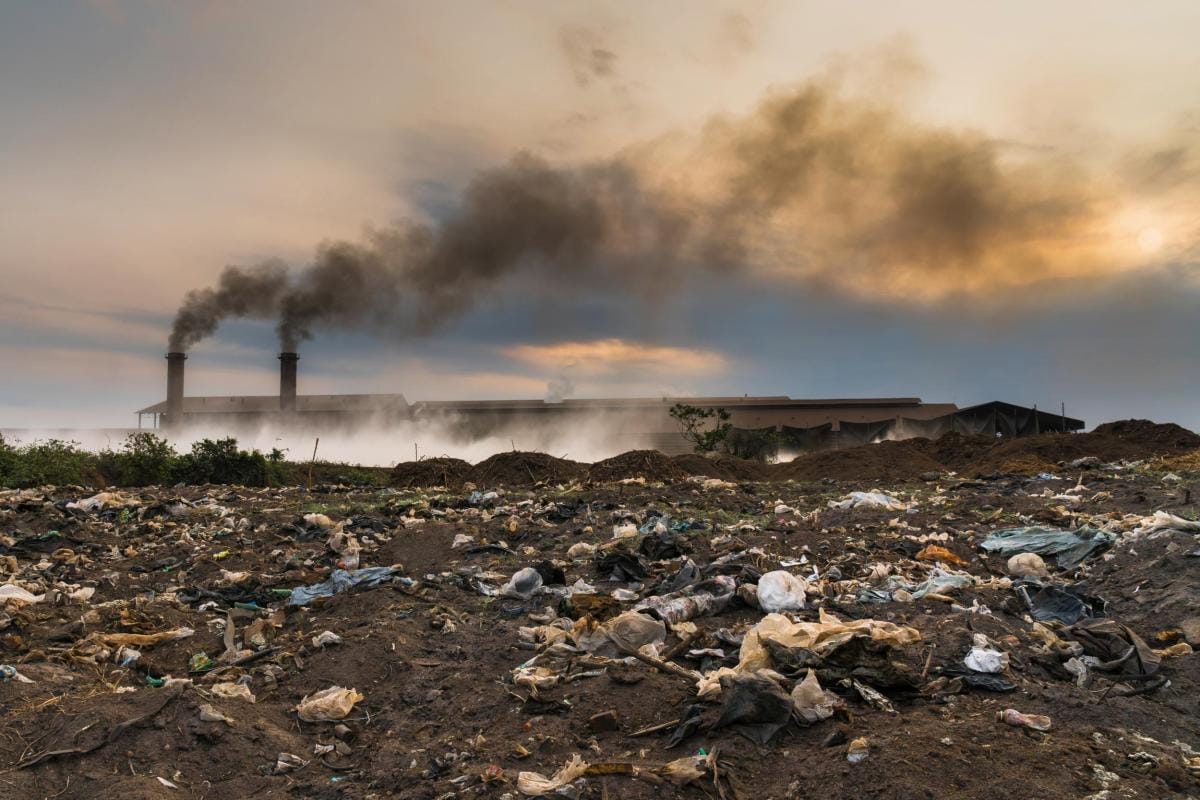 garbage in front of smokestack factory industry a 2024 02 23 05 04 26 utc