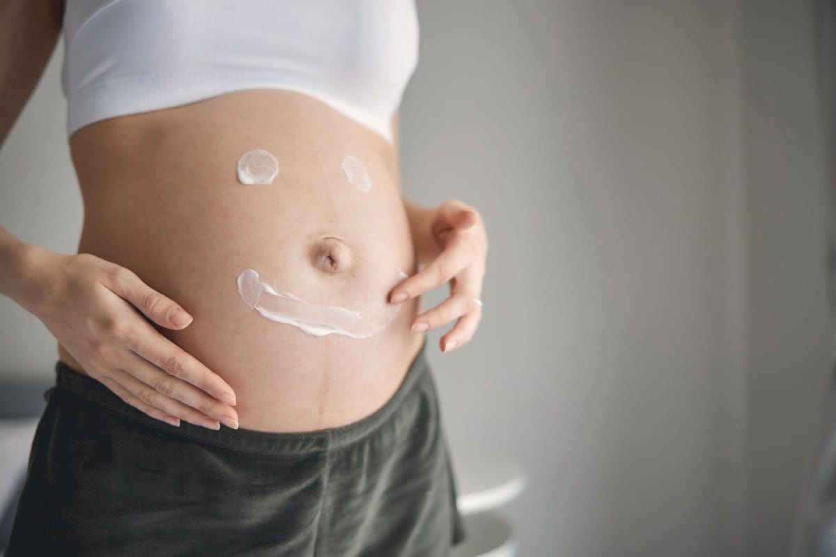 pregnant young woman applying cream on her belly a 2023 11 27 05 12 09 utc