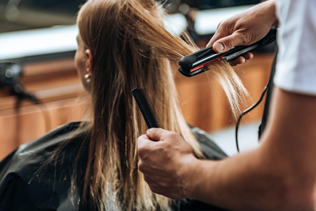 cropped shot of hairstylist holding comb and using 2023 11 27 05 10 48 utc