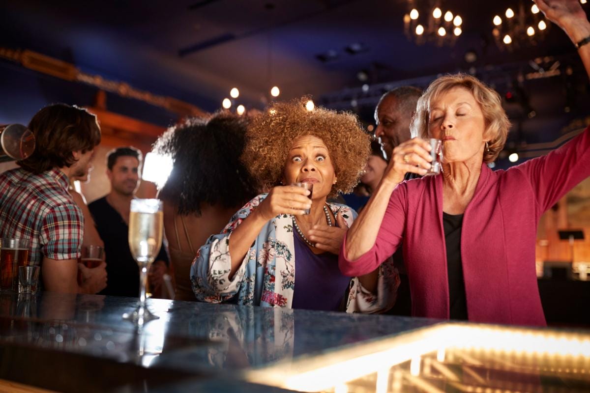 Diverse group enjoying drinks at lively bar