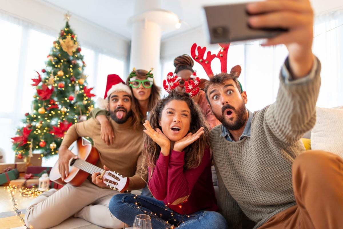 Friends taking selfie during Christmas celebration