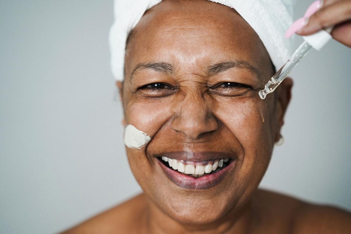 senior african woman applying hyaluronic drop and 2023 11 27 05 29 27 utc