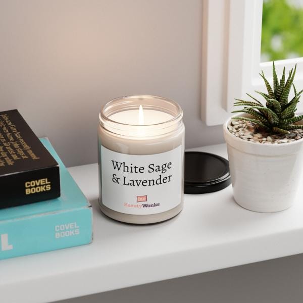 Lit White Sage & Lavender candle by window with plant