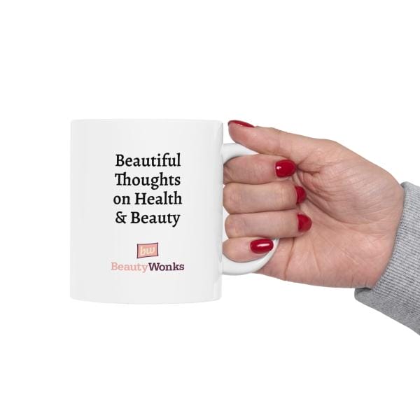 Hand holding mug with health and beauty quote