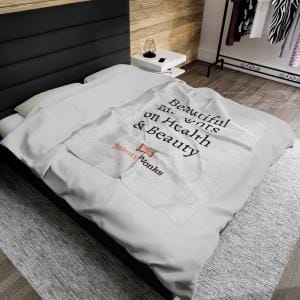 Text-printed throw blanket on modern bedroom bed