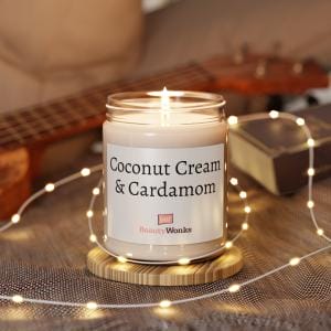 Lit coconut cream and cardamom scented candle with fairy lights