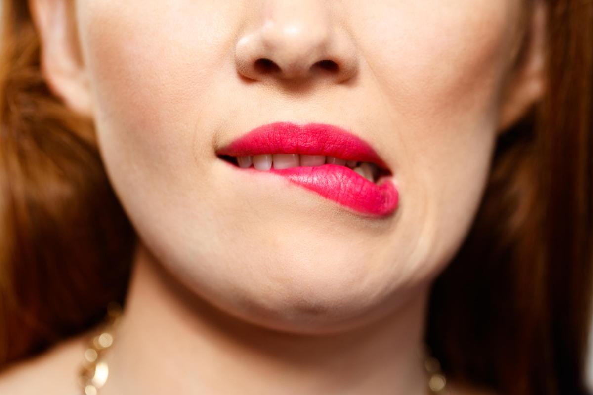 Close-up of woman's lips with bright pink lipstick