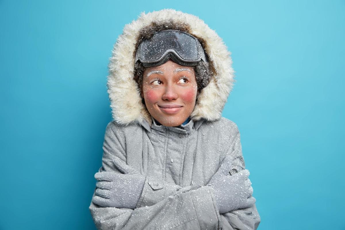 Woman in snowy winter outfit smiling