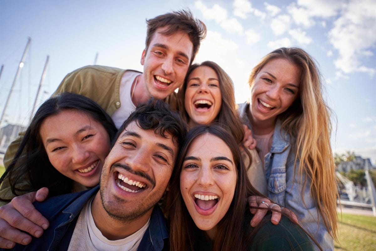 Group of joyful diverse friends outdoors laughing