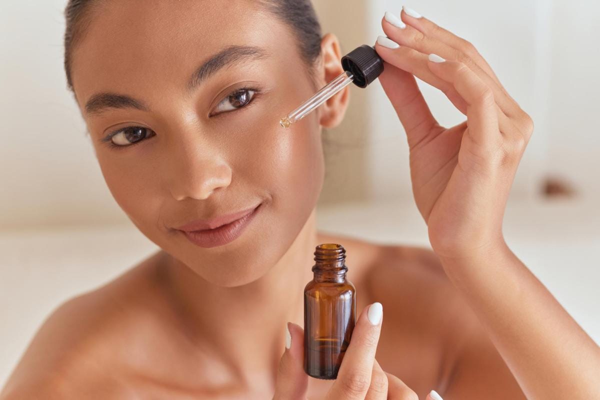 Woman applying facial serum for skincare routine