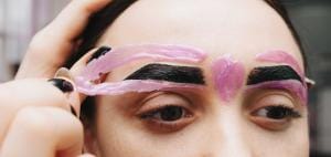 Person applying pink eyebrow tinting gel