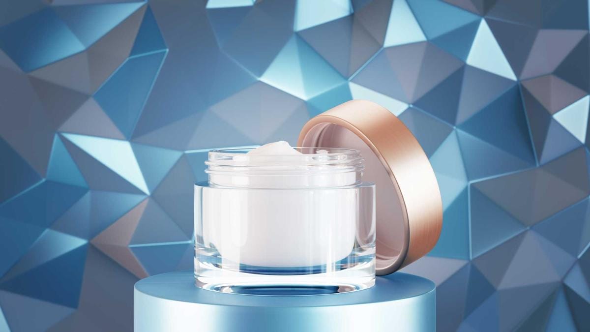 Moisturizer cream jar on geometric blue background