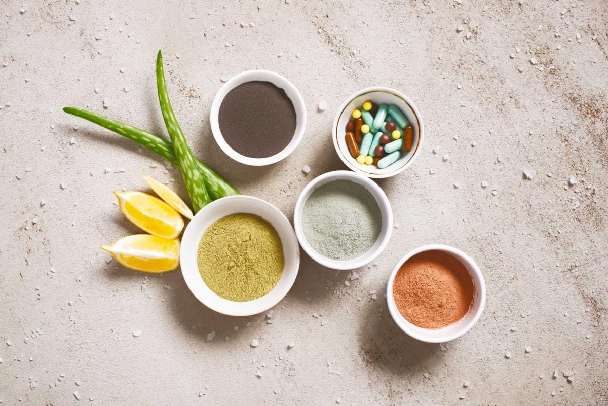 Various health supplements and powders on textured surface