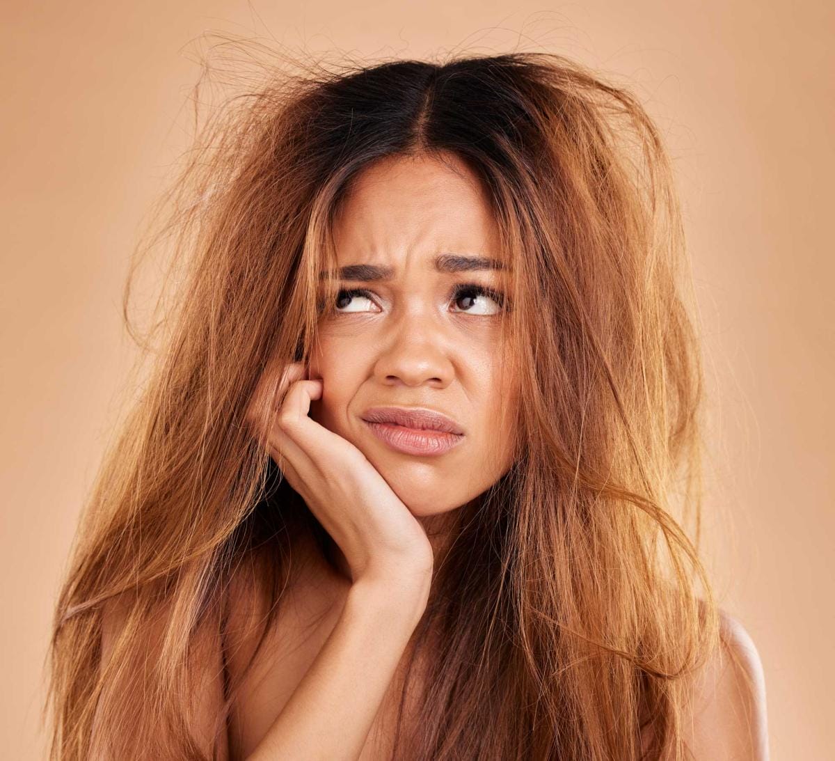 Concerned woman with tousled hair looking upward