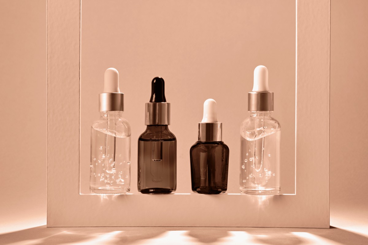 Elegant skincare dropper bottles in illuminated display