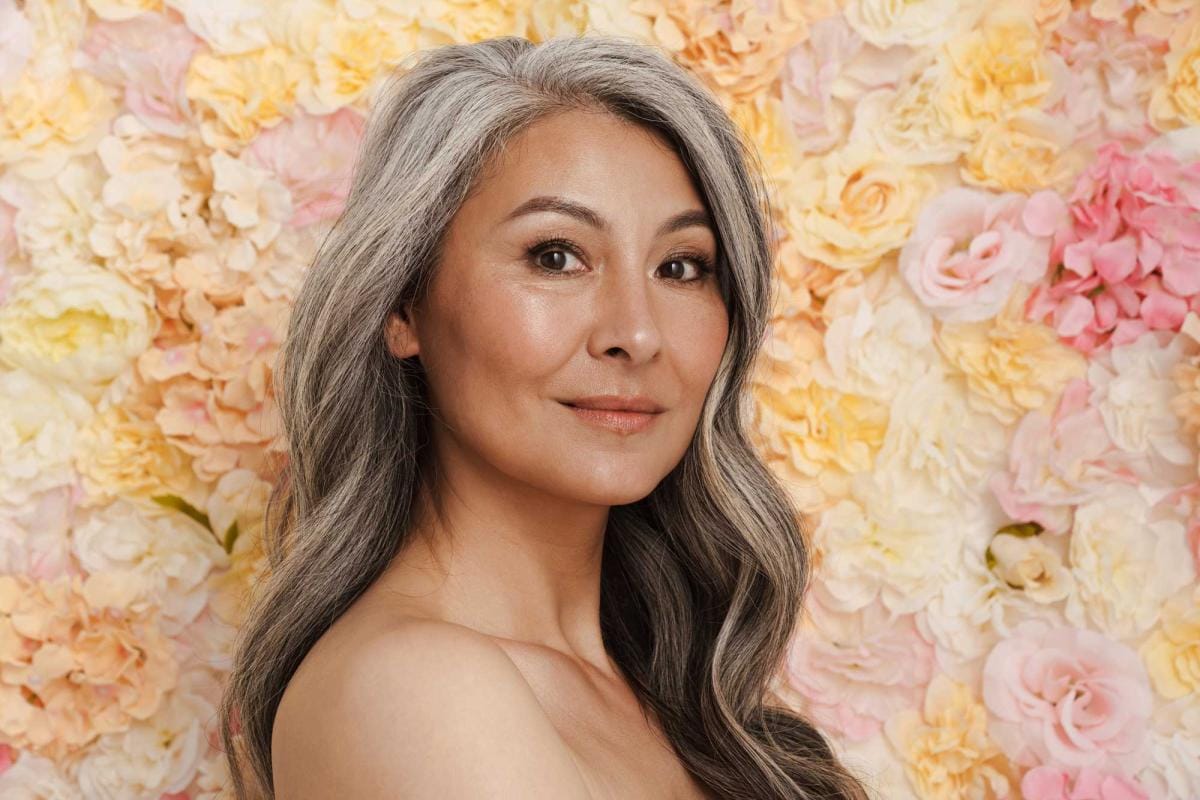 Mature woman with floral background