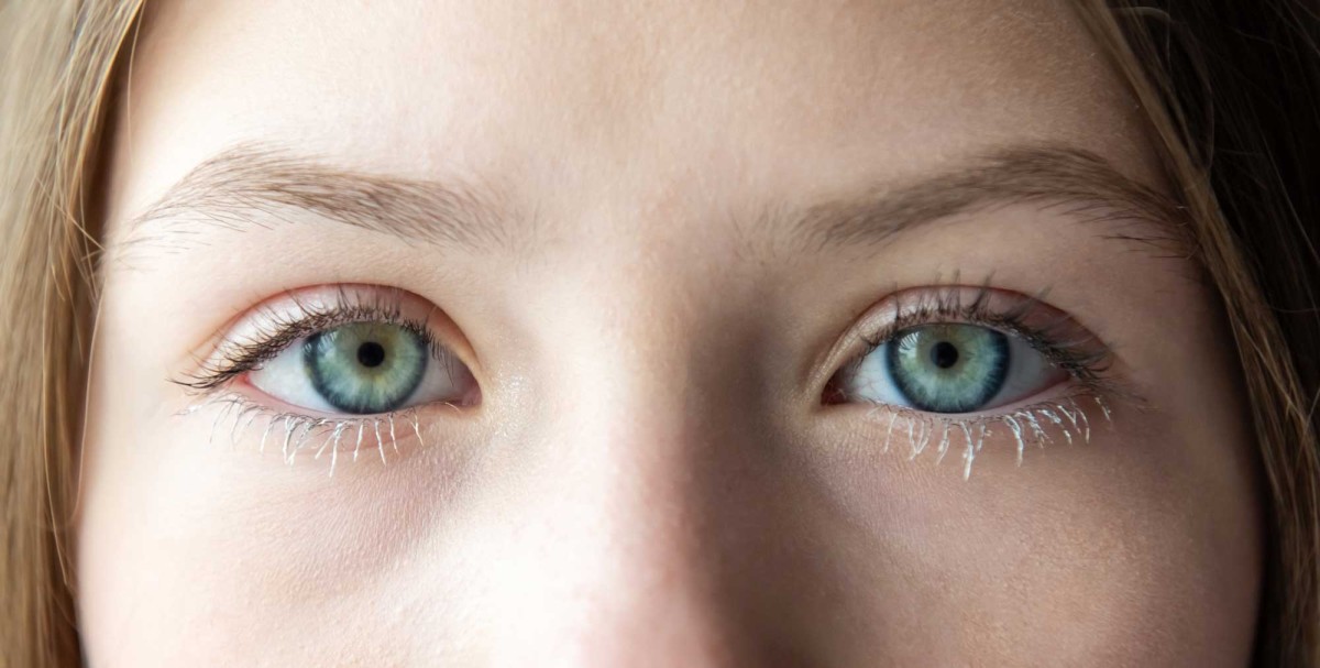 Close-up of young woman's blue-green eyes