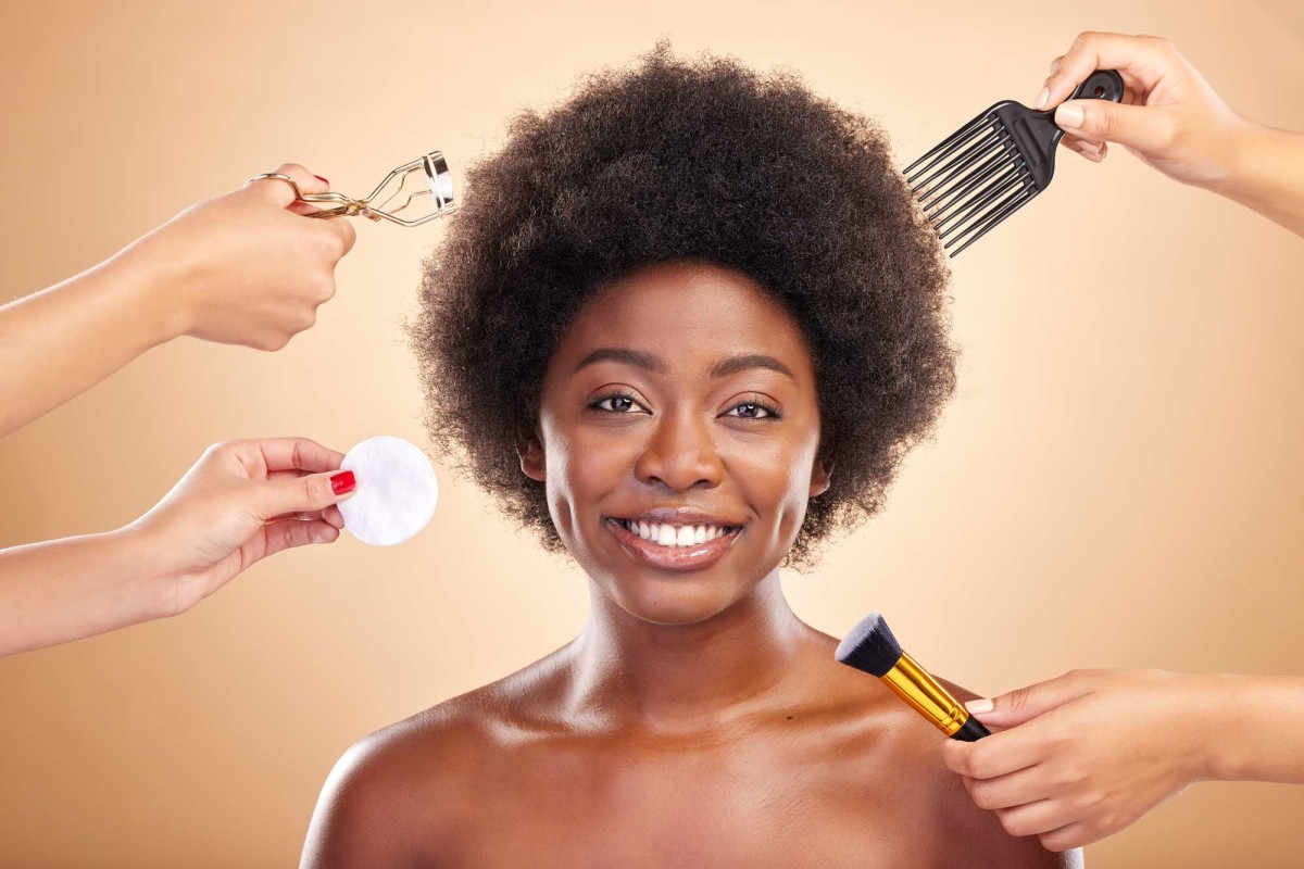 Woman receiving makeup and hair styling assistance