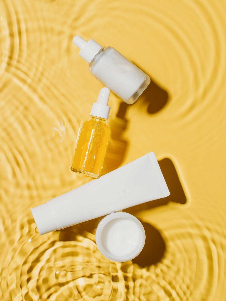 Skincare products on textured yellow background