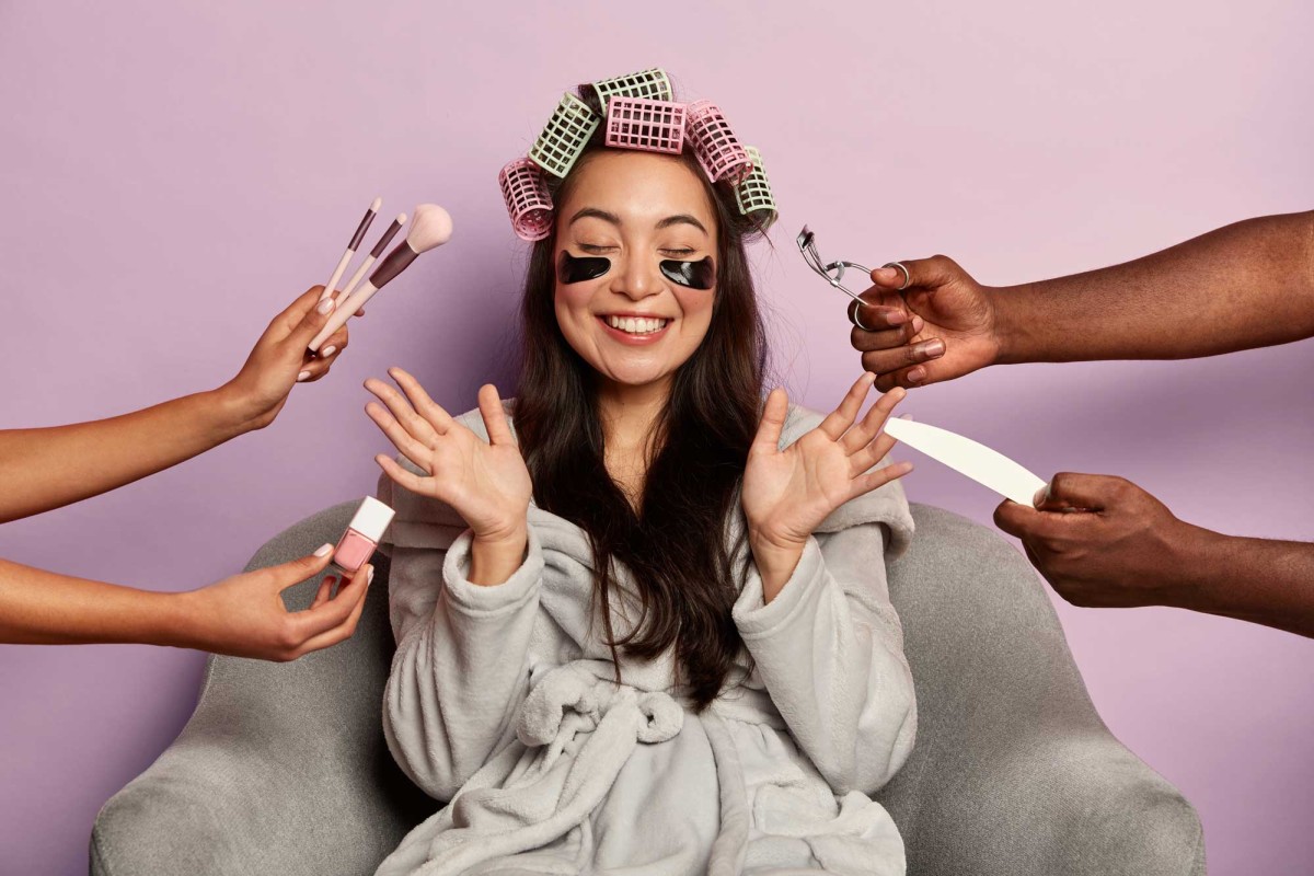 Woman enjoying makeover with multiple hands helping