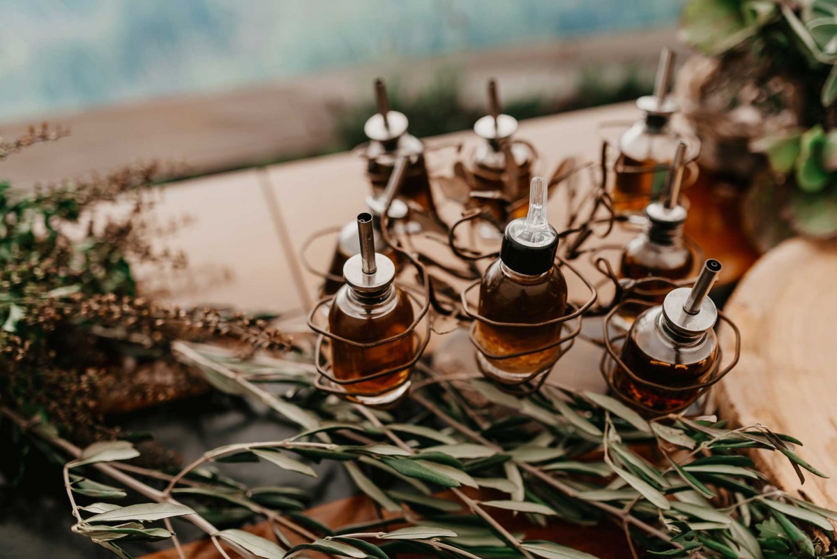 Assorted essential oil dispensers with fresh herbs