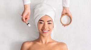 Woman receiving facial treatment with natural products