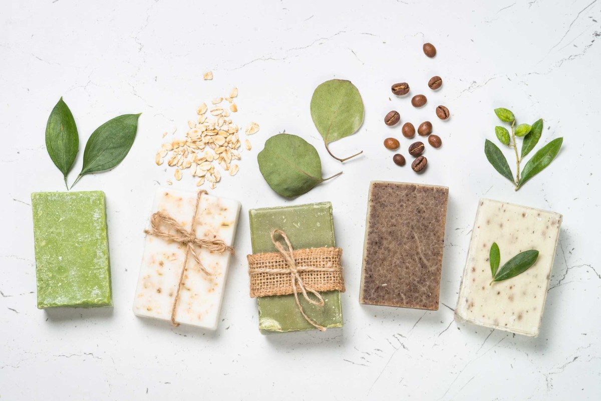 Assorted natural handmade soap bars with botanical elements