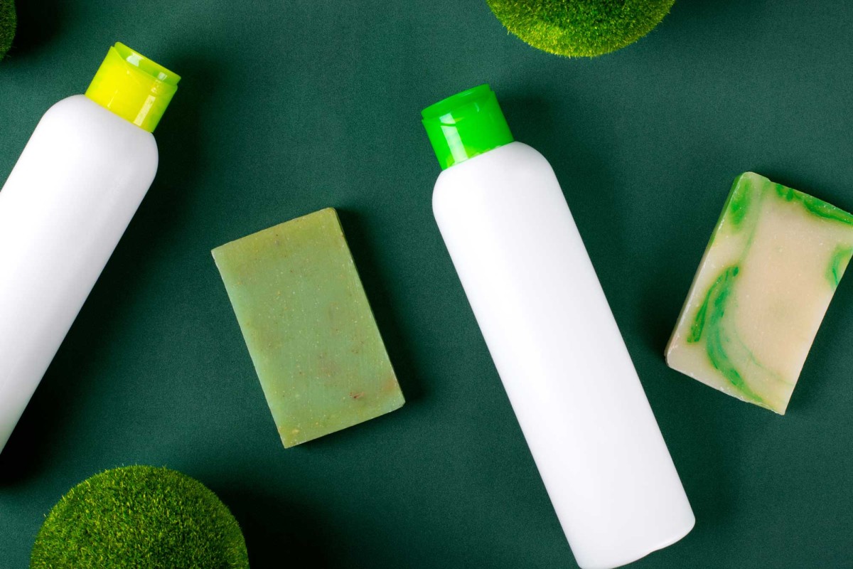 Green eco-friendly skincare products on dark background