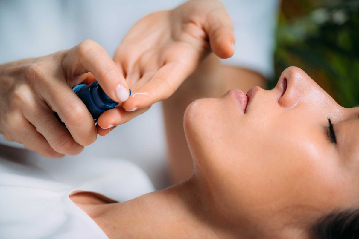 Woman receiving facial serum treatment